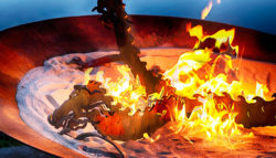 A metal dragon sculpture breathes fire.