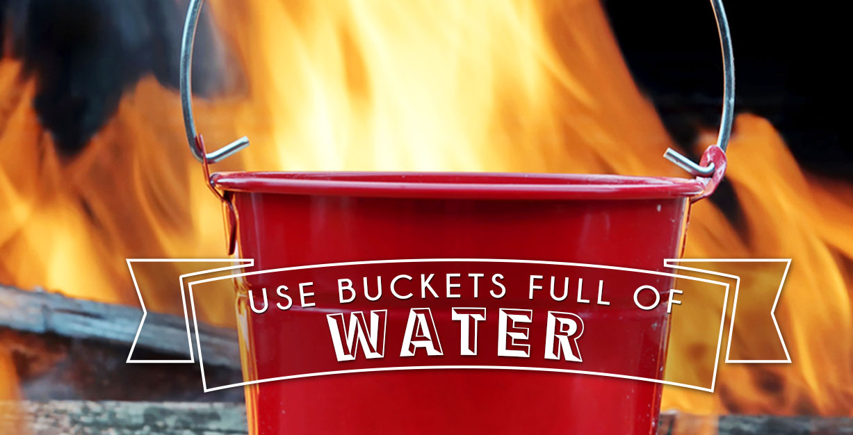 Use buckets of water to put out a fire pit.